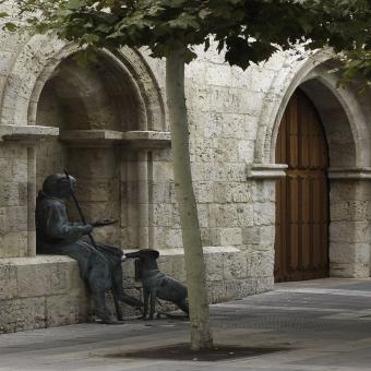 Leproso y su perro junto a la puerta de la Iglesia de San Lázaro
