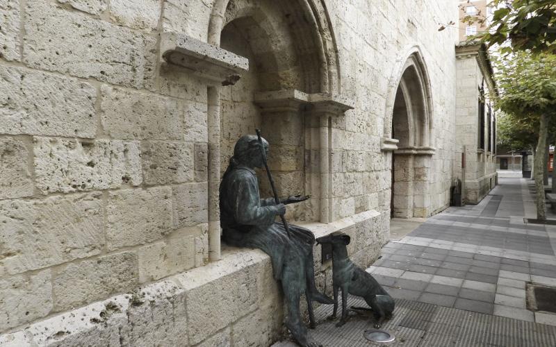 Leproso y su perro junto a la puerta de la Iglesia de San Lázaro